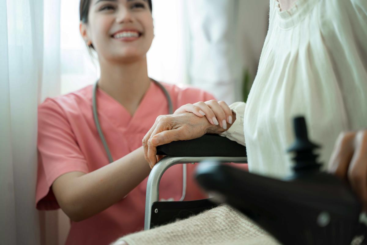 female-caregiver-holding-hands-lady