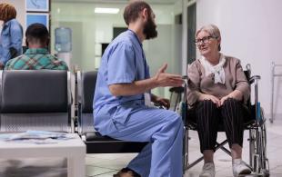 male-nurse-consulting-woman-with-chronic-disabilit